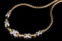 Lot 717 - White and yellow gold necklace with pavé set...