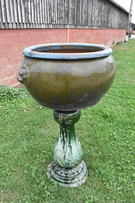 Lot 1185 - Large turquoise glazed ceramic planter with mask handles