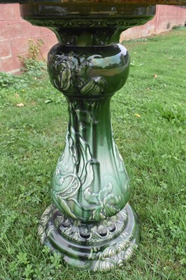 Lot 1185 - Large turquoise glazed ceramic planter with mask handles