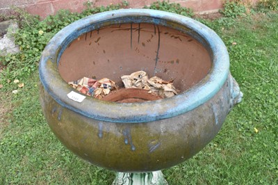 Lot 1185 - Large turquoise glazed ceramic planter with mask handles