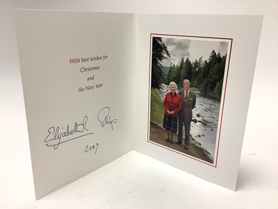 Lot 32 - H.M. Queen Elizabeth II and H.R.H. The Duke of Edinburgh, signed 2009 Christmas card with twin gilt Royal cyphers to the cover, colour photograph to the interior of the Royal couple in the Highla...