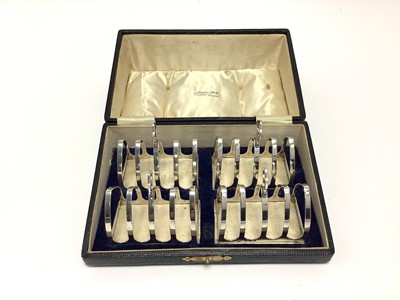 Lot 212 - Set of four silver toast racks in fitted case