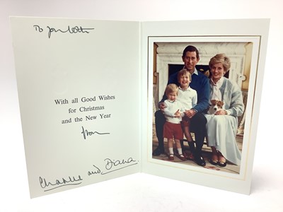 Lot 63 - T.R.H. The Prince and Princess of Wales, signed 1986 Christmas card with twin gilt Royal cyphers to cover, colour photograph of the smiling couple with their two young sons and a puppy, signed an...