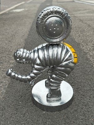 Lot 86 - Reproduction cast aluminium model of Mr Bibendum (The Michelin man) with a tyre on his back, 30cm in overall height.