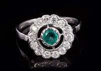 Lot 751 - Emerald and diamond cluster ring with central...