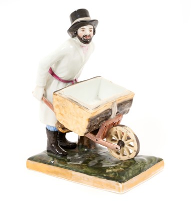 Lot 70 - Russian Gardner porcelain figure of a man pushing a wheelbarrow, on a gilt-lined rectangular base, impressed marks, 16cm high