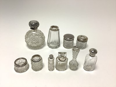 Lot 250 - Collection of silver lidded dressing table jars and bottles. (10)