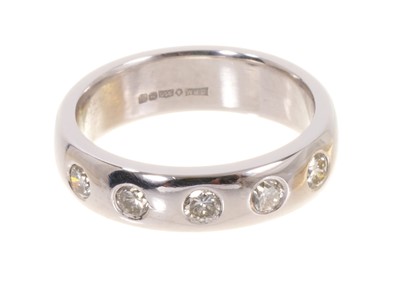 Lot 491 - Platinum and diamond eternity ring with five brilliant cut diamonds estimated to weigh approximately 0.50ct in total, in platinum rub-over setting