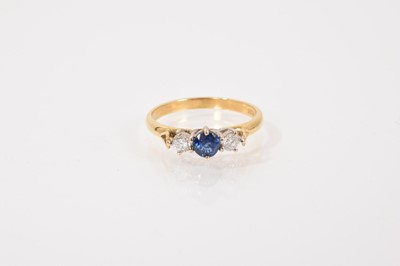 Lot 43 - Sapphire and diamond three stone ring with a central mixed cut blue sapphire flanked by two brilliant cut diamonds