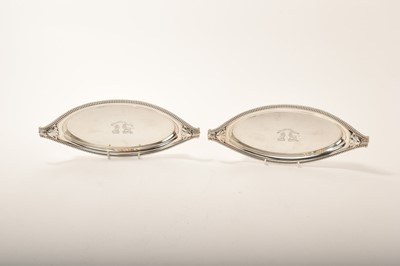 Lot 325 - Pair of good quality George III silver snuffer trays of oval shaped form, with double engraved armorial crests and motto (London 1804), by William Stroud, 28cm wide