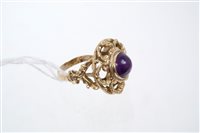 Lot 785 - Unusual amethyst dress ring with a round...