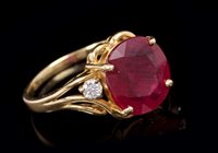 Lot 793 - Ruby and diamond ring with a cushion cut ruby...