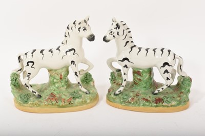 Lot 96 - Pair of Staffordshire pottery zebras