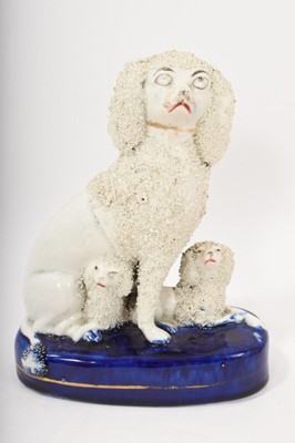 Lot 148 - 19th century Staffordshire pottery group of a poodle and two puppies