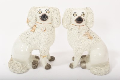 Lot 139 - Pair of late 19th century Staffordshire pottery models of seated poodles