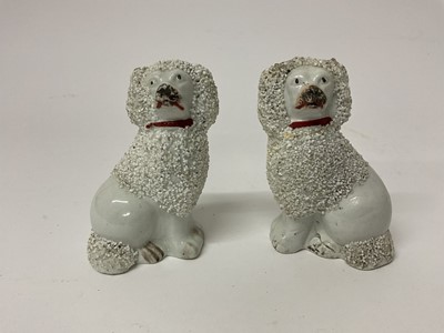 Lot 687 - Pair of 19th century Staffordshire pottery small models of seated poodles