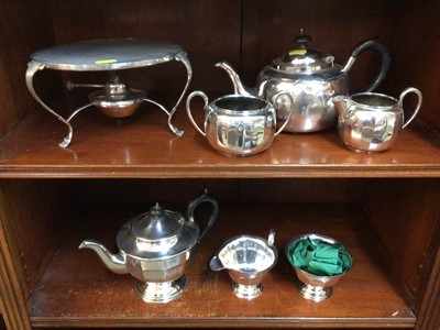 Lot 601 - Two silver plated three piece tea sets and a stand