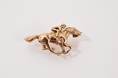 Lot 54 - Yellow metal brooch in the form of a jockey on racehorse, tests as approximately 9ct gold.