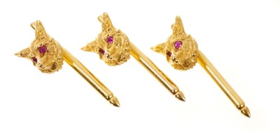 Lot 404 - Three 14ct gold hunting studs/buttons, the fox masks with ruby eyes, on a spring loaded gold pins