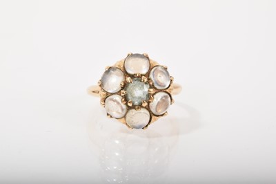 Lot 406 - Aquamarine and moonstone cluster ring with a central mixed cut aquamarine surrounded by six moonstone cabochons in gold claw setting on a tapered gold shank, size P