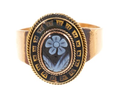 Lot 421 - Victorian carved sardonyx and black enamel mourning ring with a central cameo carved forget-me-not with a black enamel border on a tapered gold shank. Ring size N