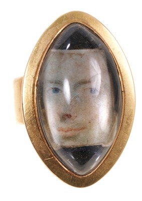 Lot 424 - Georgian portrait ring with a portrait miniaure of a gentlemen's face under a domed crystal in oval gold mount with locket compartment to the reverse, engraved Thomas Gillatt ob. 13th June 1793...