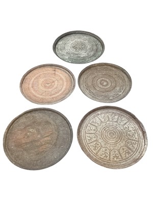 Lot 1174 - Five Middle Eastern and Indian engraved brass dished circular trays - three with Arabic script