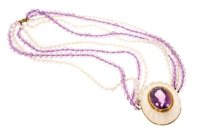 Lot 433 - Amethyst and frosted glass gold mounted necklace, the central oval mixed cut amethyst in a reeded frosted glass mount set in gold on a multi-strand amethyst and frosted glass bead necklace with...