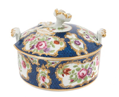 Lot 24 - Worcester butter tub and cover, c.1770, polychrome decorated with flowers within gilt scrollwork cartouches, on a blue scale ground, the cover with flower finial, crescent mark to base, 10.5cm d...