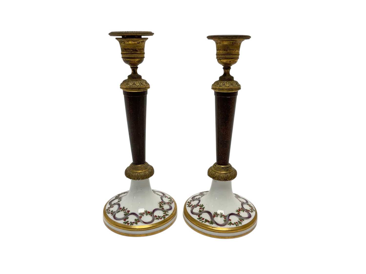 Lot 103 - Formerly the gift of Napoleon Bonaparte, Pair Early 19th century French Paris porcelain, simulated porphyry and ormolu mounted candlesticks