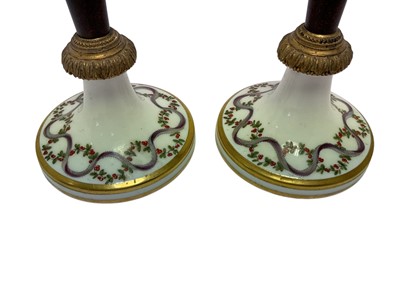 Lot 103 - Formerly the gift of Napoleon Bonaparte, Pair Early 19th century French Paris porcelain, simulated porphyry and ormolu mounted candlesticks