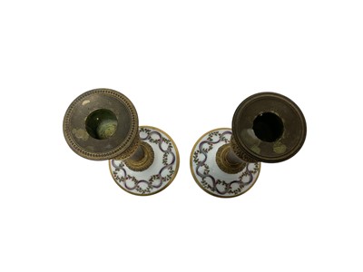 Lot 103 - Formerly the gift of Napoleon Bonaparte, Pair Early 19th century French Paris porcelain, simulated porphyry and ormolu mounted candlesticks