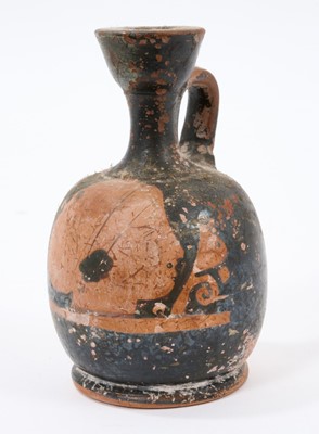 Lot 881 - Small Ancient Etruscan aryballos portrait ewer, with flared rim and loop handle, 11cm high