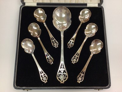 Lot 1023 - 1960s set of six silver spoons and a matching silver serving spoon, all with pierced decoration in fitted case (Sheffield 1961 and 1962)