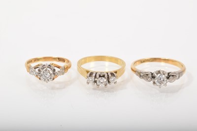 Lot 527 - Three diamond rings to include a three stone ring and two single stone rings, all in platinum settings on 18ct gold shanks