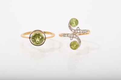 Lot 528 - Edwardian peridot and diamond crossover ring with scroll design on 14ct gold shank, ring size N and an Edwardian peridot single stone ring in platinum mounted 15ct gold setting, ring size O