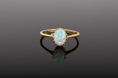 Lot 529 - Edwardian opal single stone ring with an oval opal cabochon in claw setting on 18ct gold shank. Ring size P