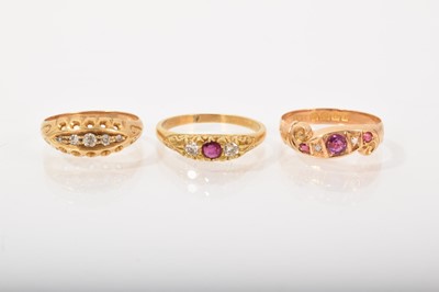 Lot 530 - Three antique 18ct gold diamond and gem set rings in carved scroll settings to include a diamond five stone ring, ruby and diamond five stone ring and a ruby and diamond three stone ring