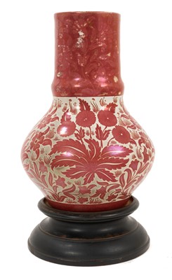 Lot 27 - William de Morgan ruby lustre pottery vase, decorated with foliate patterns, impressed mark and inscribed 'FP' for Fred Passenger, 23.5cm high, together with carved wood base