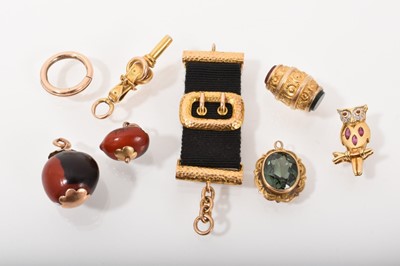 Lot 538 - Group of antique charms to include Victorian gold/yellow metal watch key in the form of a belt buckle and rings, Victorian gold and agate barrel fob, gold split ring, 18ct gold owl brooch, gold...