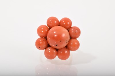 Lot 543 - Coral cluster dress ring with a flower shape head on tapered gold shank. Ring size M