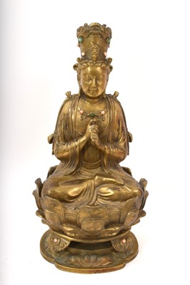 Lot 682 - Tibetan gilt metal Buddha figure, seated on lotus base, applied with coral cabouchons, 30cm high