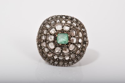 Lot 569 - Antique emerald and diamond cluster ring with a central step cut emerald surrounded by three concentric borders of rose cut diamonds in silver setting, engraved gold gallery on gold shank with s...