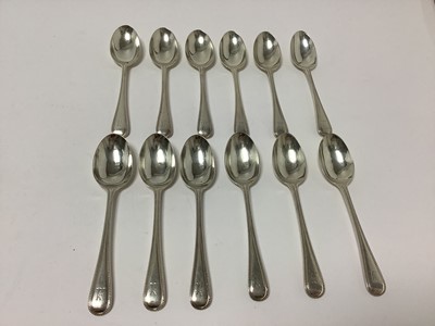 Lot 309 - Set of twelve silver Old English Bead Edge pattern teaspoons with engraved armorial crest