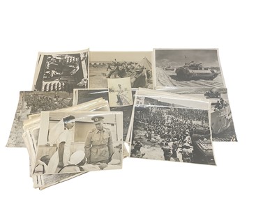 Lot 731 - Group of thirty Second World War military official press photographs including George VI, Churchil and others (some duplication noted).