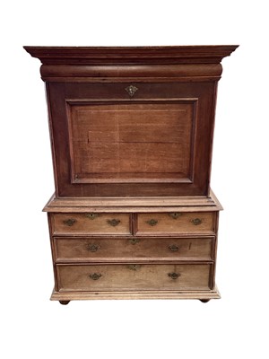 Lot 1314 - Rare 18th century Channel Islands oak escritore on stand, the upper section with hinged front enclosing extensively fitted interior of drawers and pigeonholes, the base having two short over two...