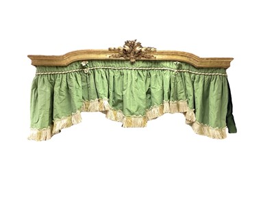 Lot 1319 - Antique giltwood pelmet with arched central section surmounted with a carved floral bouquet, a green silk panel attached, 58cm wide x 24cm deep