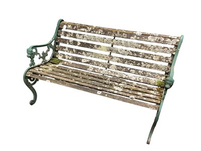 Lot 1320 - Antique garden bench with green painted scroll end standards and wooden slatted set, 127cm wide