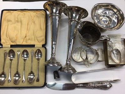 Lot 1011 - Group of silver items to include a silver 'leaf' shaped caddy spoon, silver napkin rings, pair of silver spill vases, sugar tombs and bon bon dish