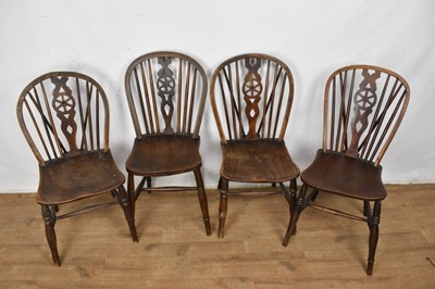 Lot 1535 - Matched set of four fruitwood ash and elm wheelback chairs